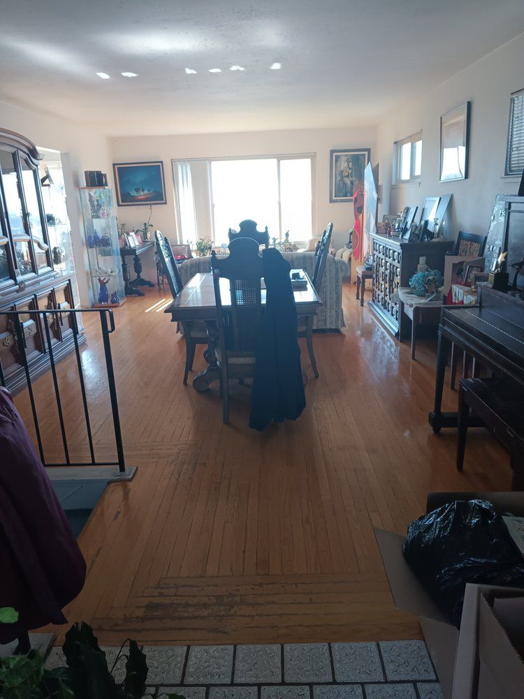 A large living room with a dining table and chairs