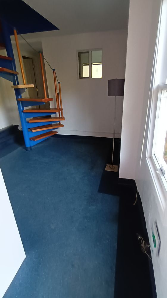 There is a spiral staircase in the middle of the room.