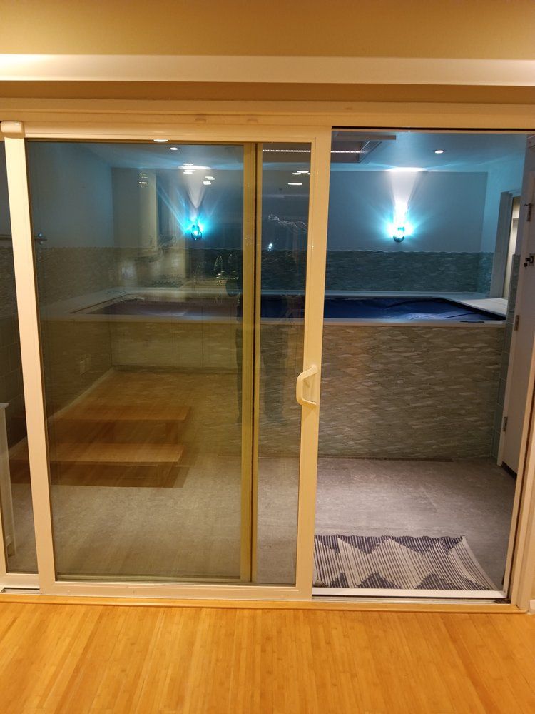 A sliding glass door leading to a swimming pool
