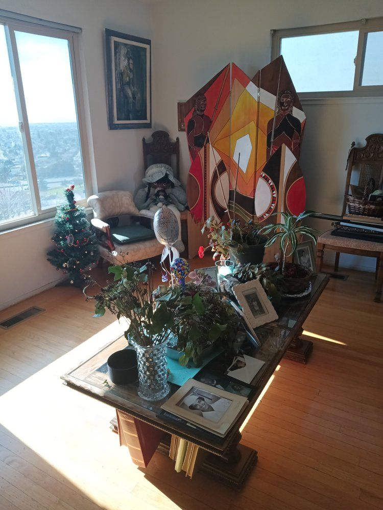 A living room with a coffee table and a christmas tree