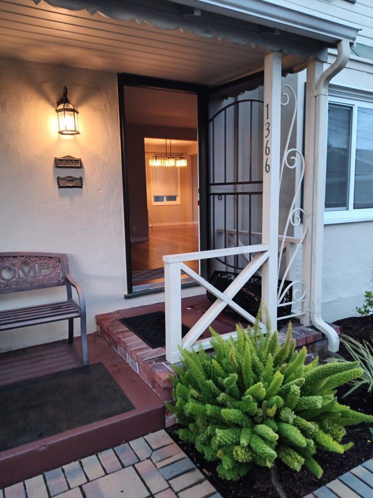 A house with a porch and a bench in front of it