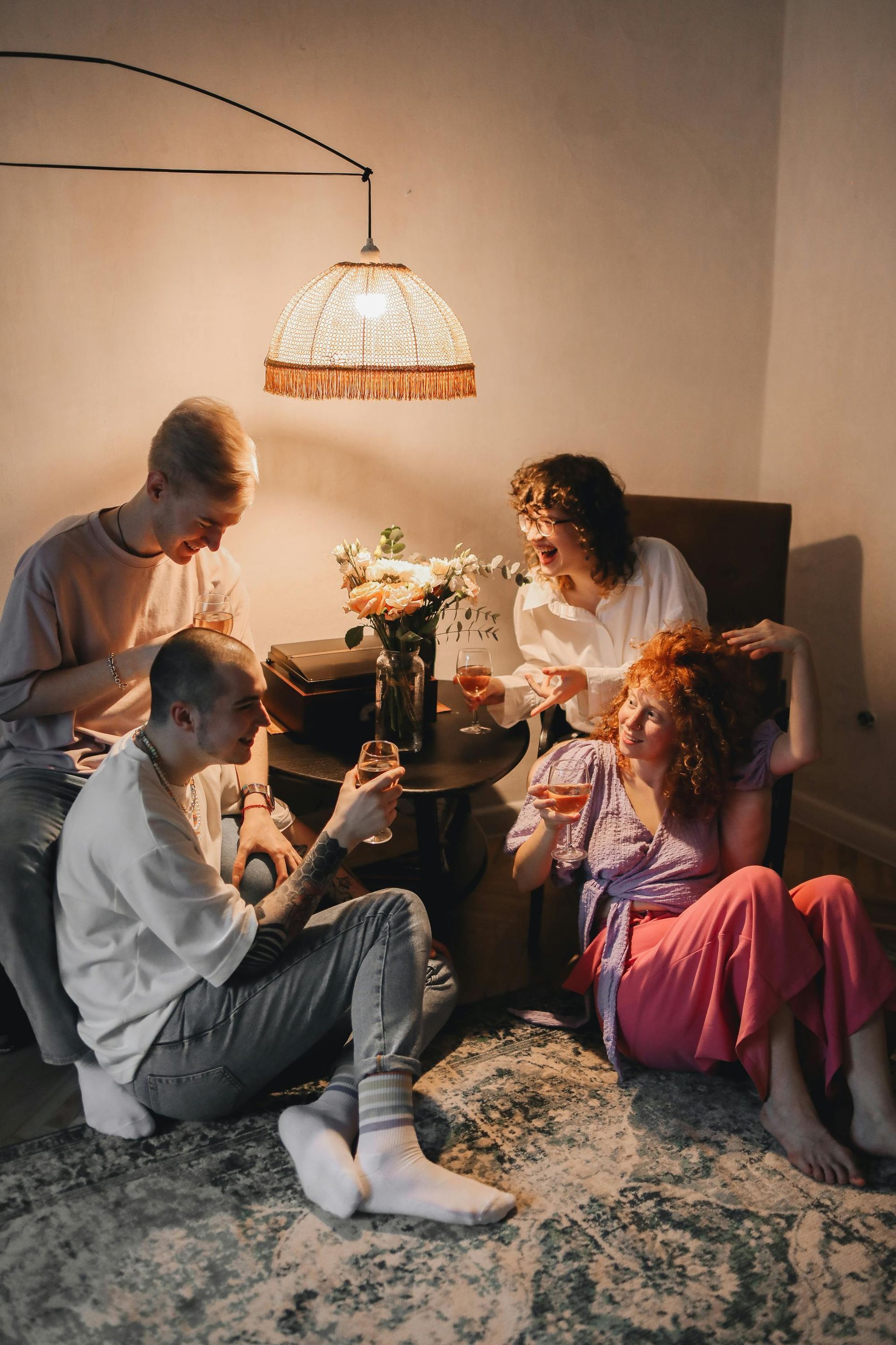 A group of people are sitting around a table drinking wine.