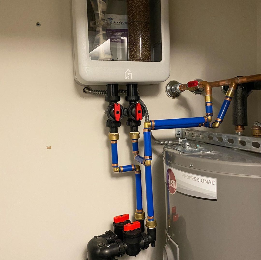 A water heater with blue pipes attached to it