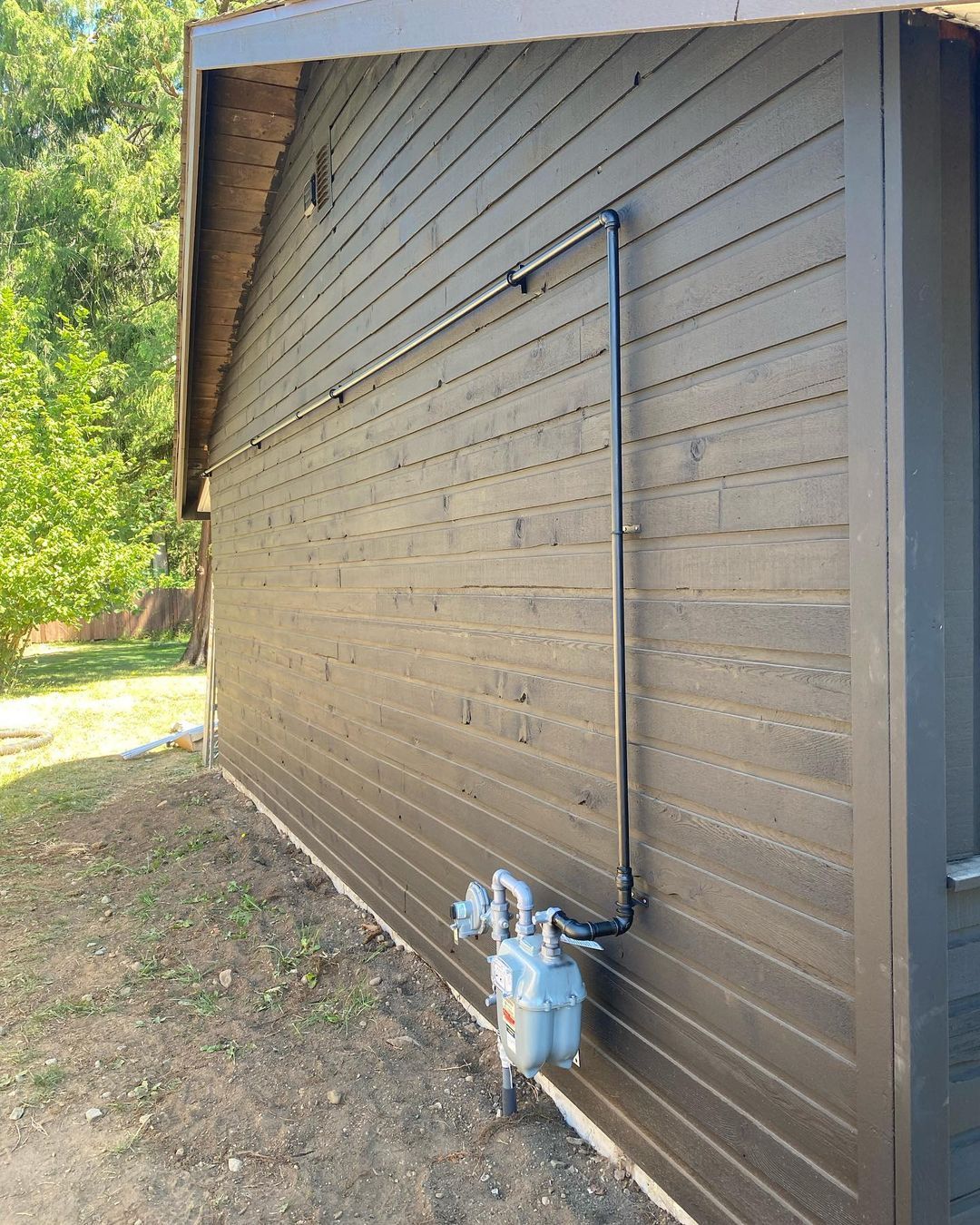 A house with a gas meter on the side of it.