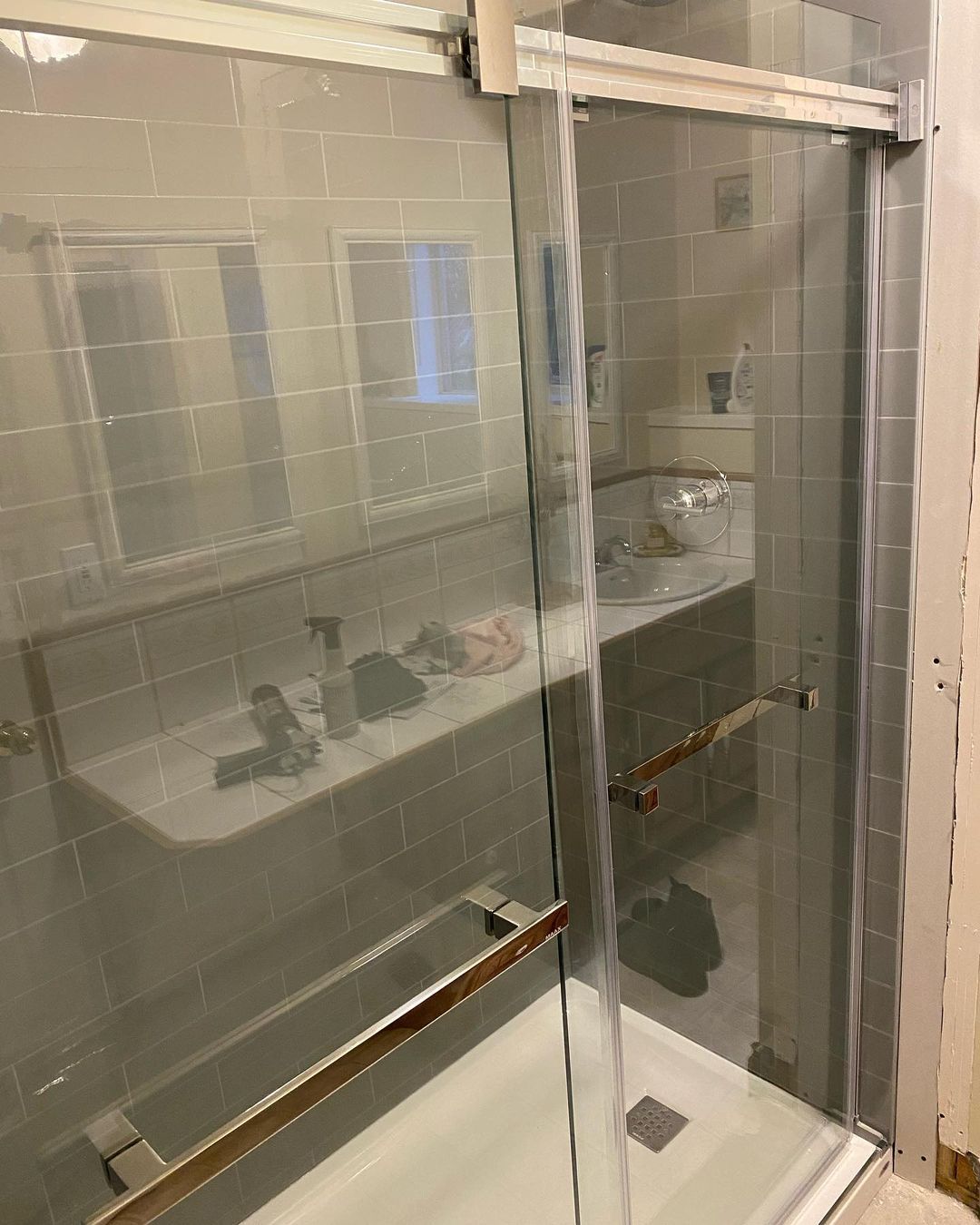 A bathroom with a sliding glass shower door and a sink.