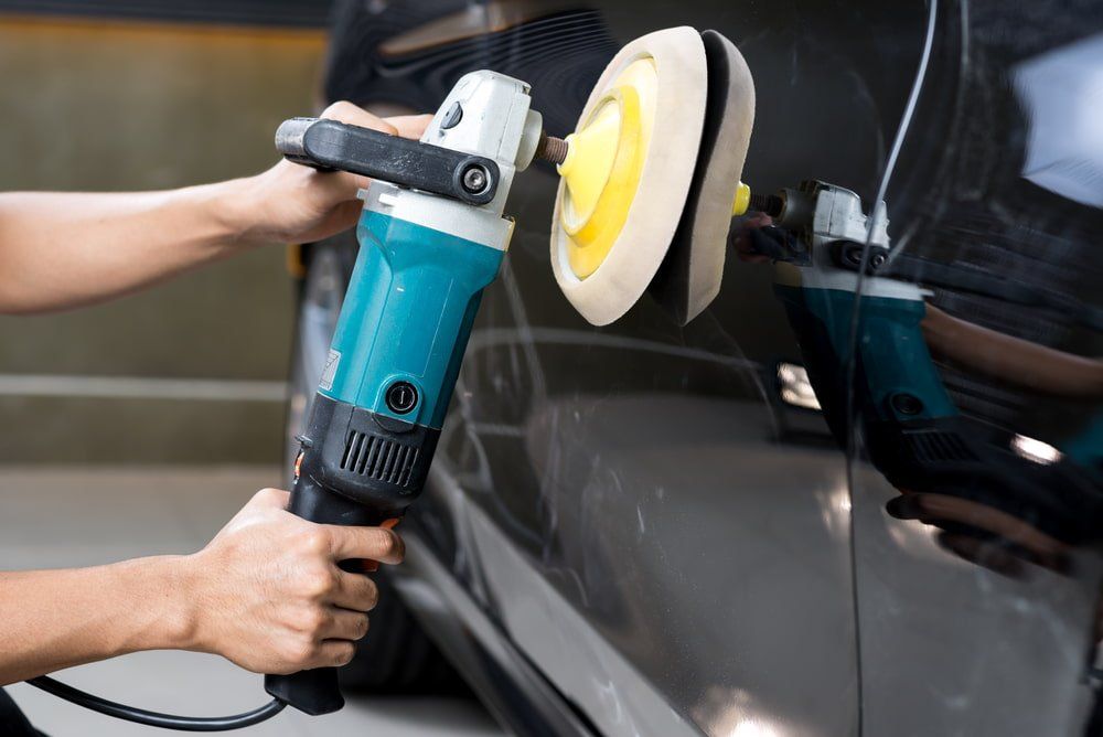 Polishing Black Car— Spray Painter in Park Avenue, QLD