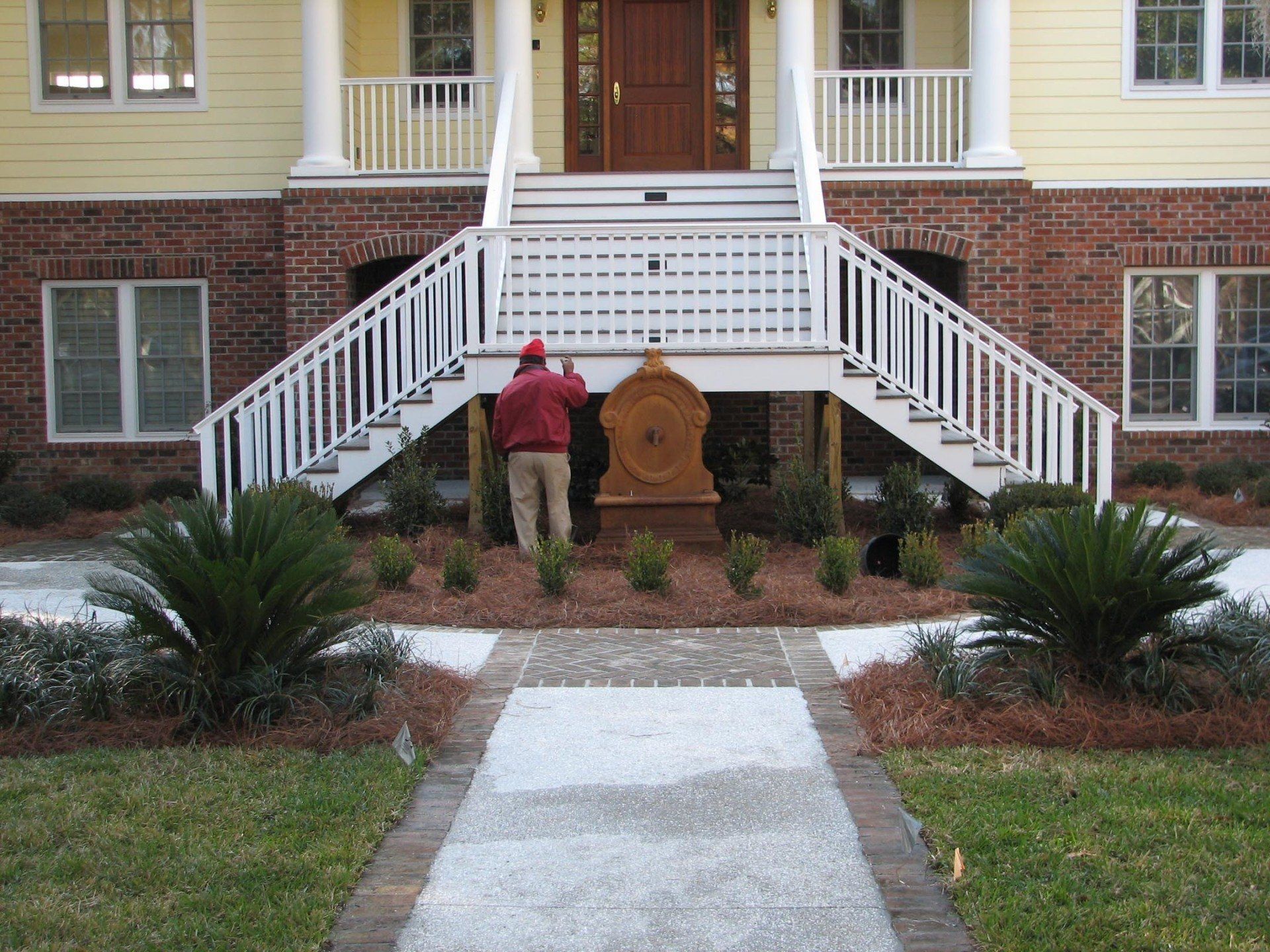 A man standing in front of a house with stairs