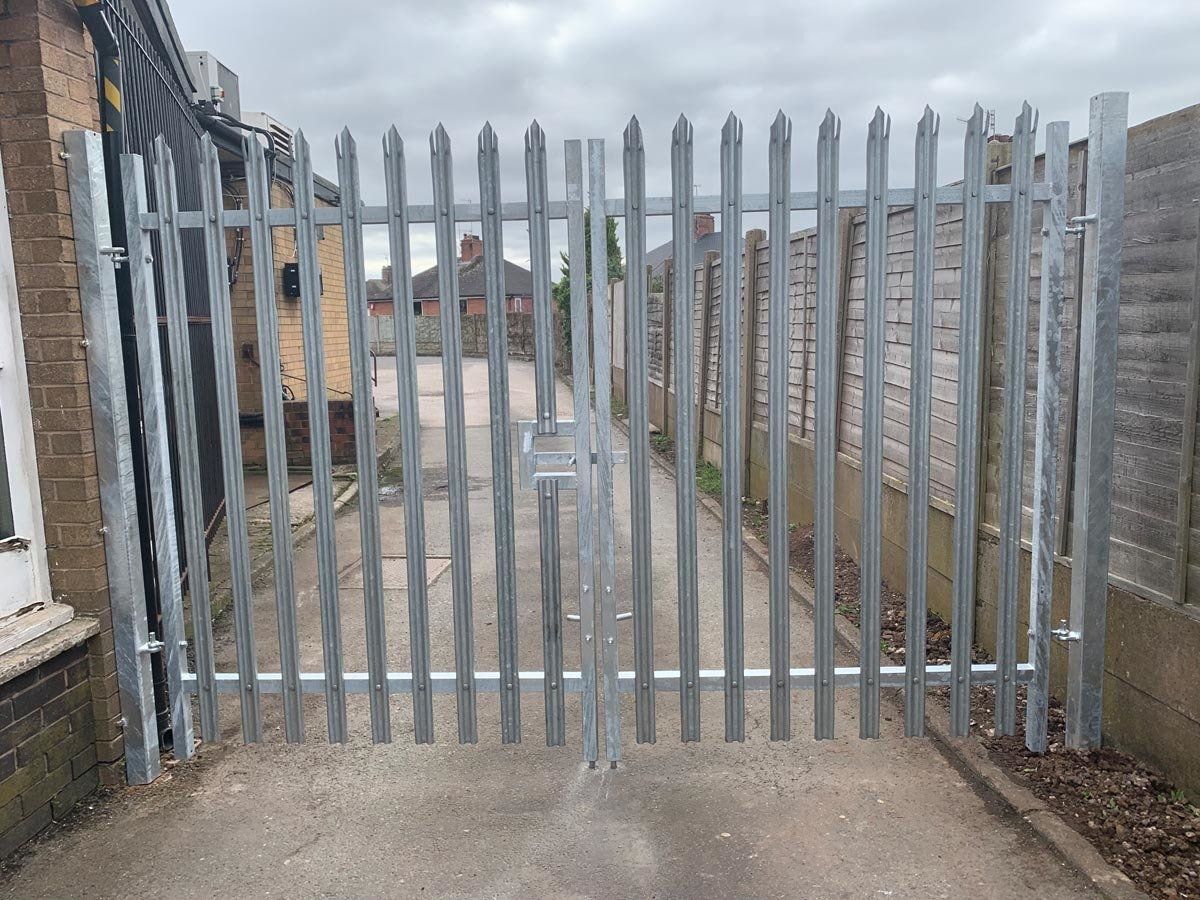 A metal fence is blocking the entrance to a building.