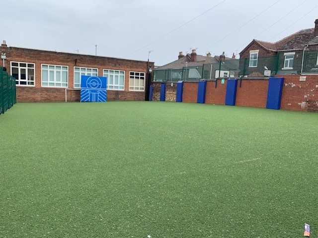 There is a basketball hoop in the middle of the field.