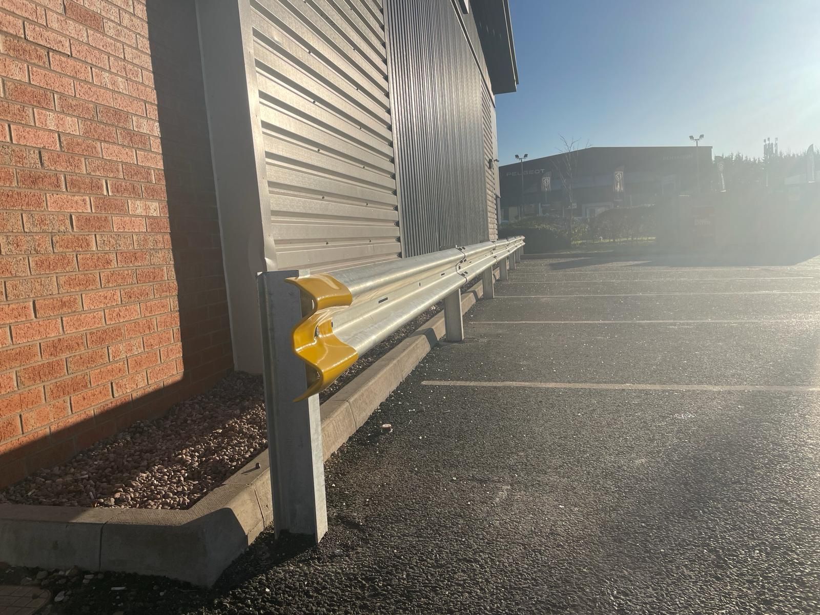 A brick building with a parking lot in front of it.