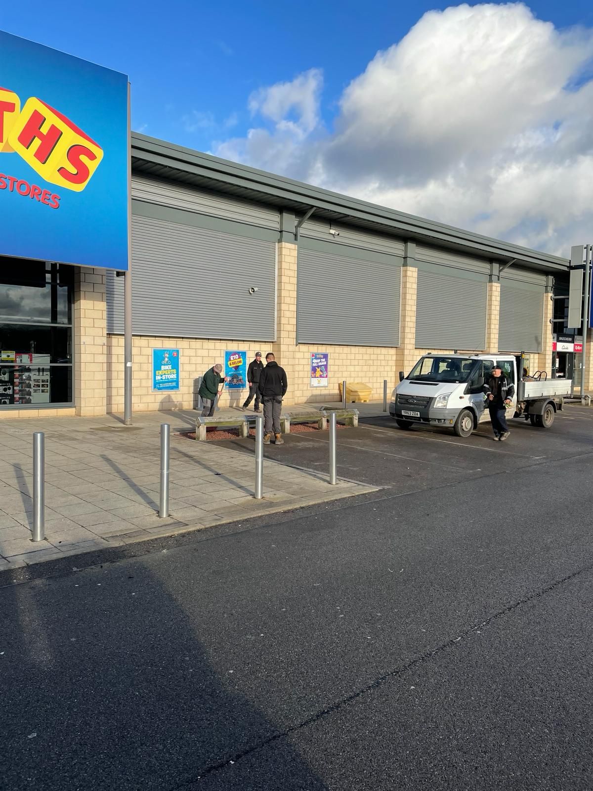 A toys r us store with cars parked in front of it