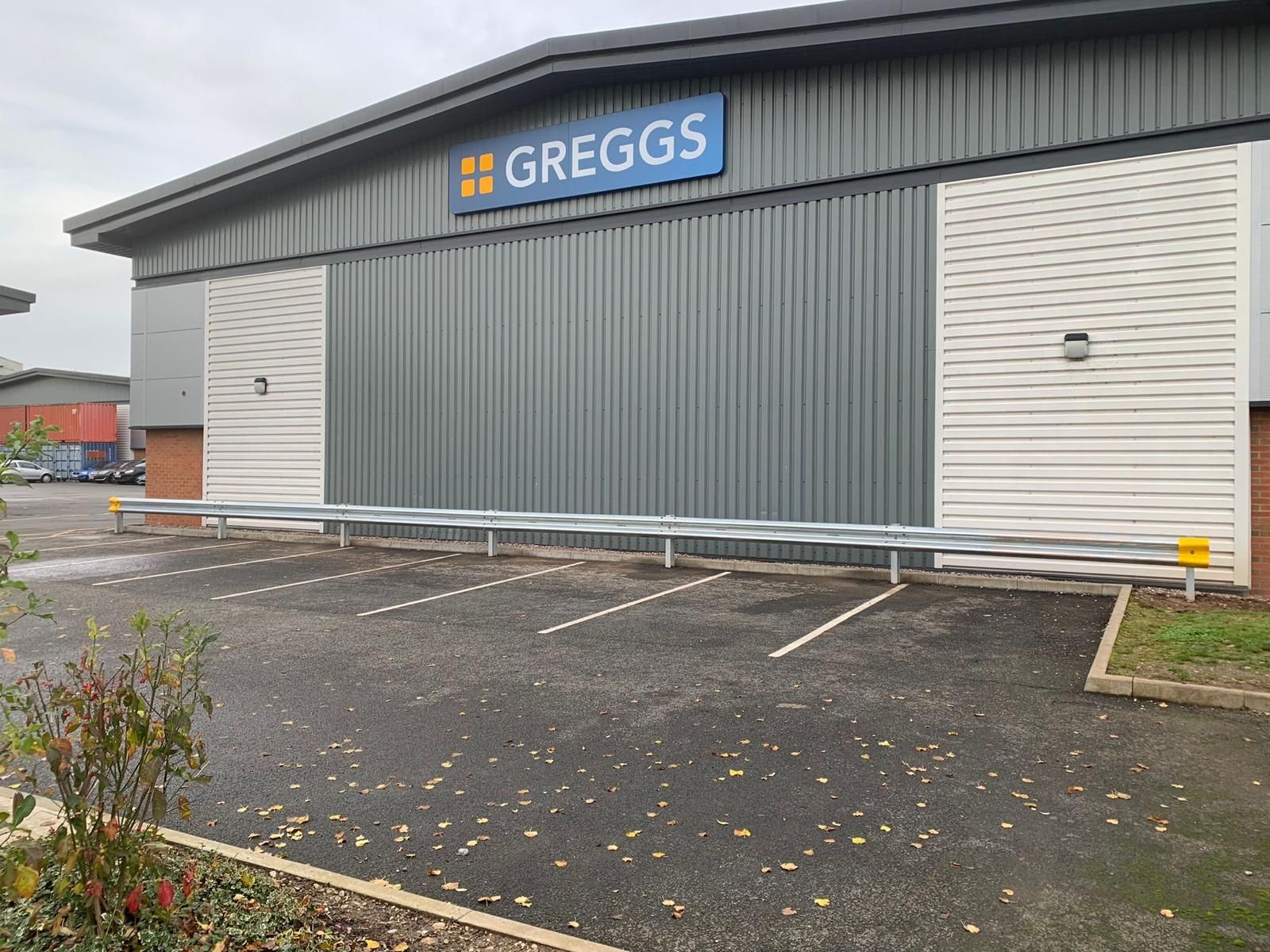 A greggs store with a parking lot in front of it