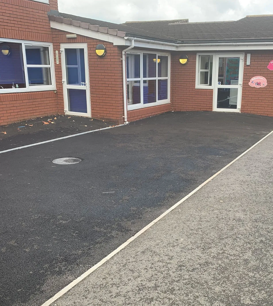 A brick building with a driveway in front of it