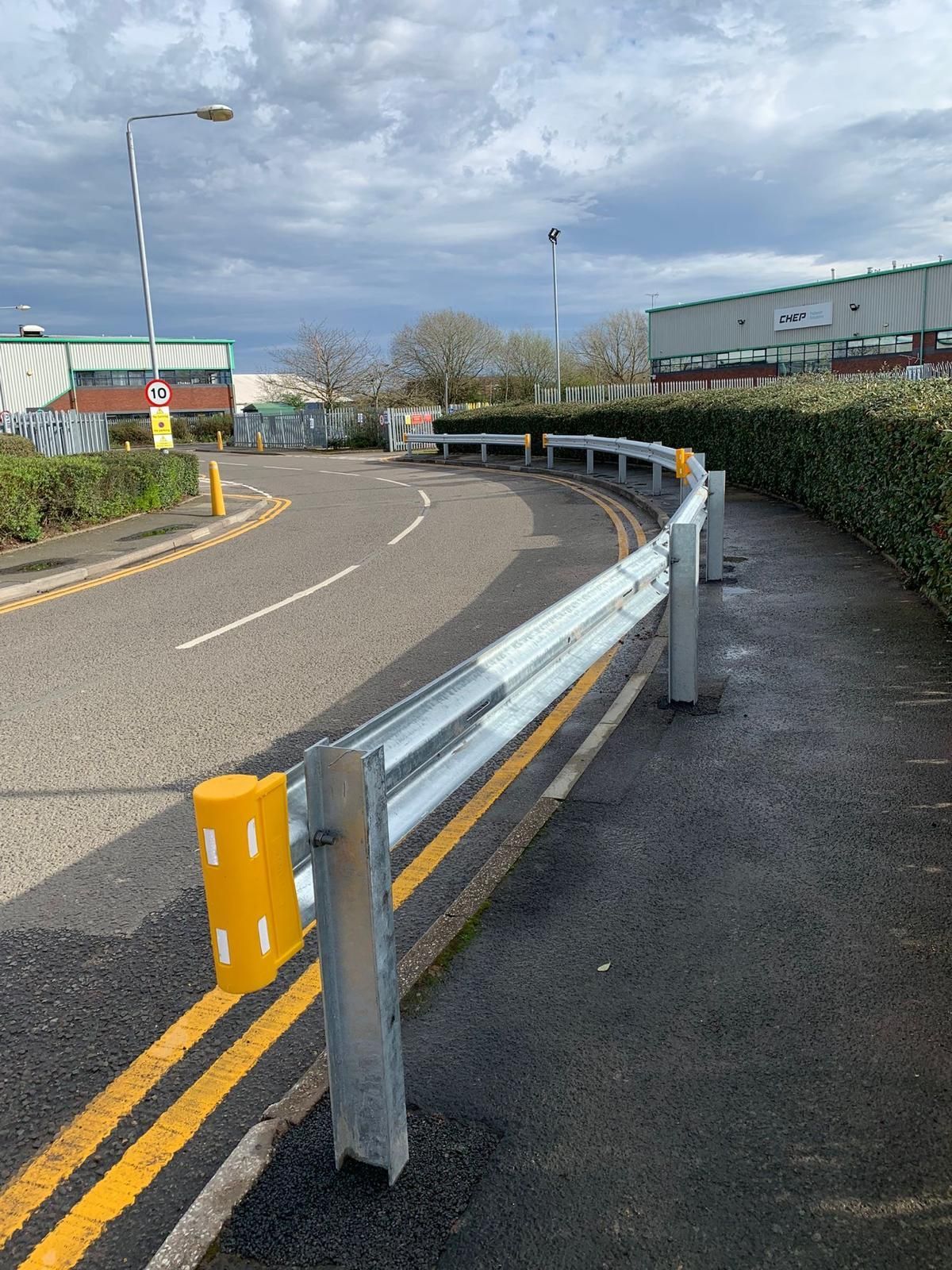 A road with a metal barrier on the side of it.