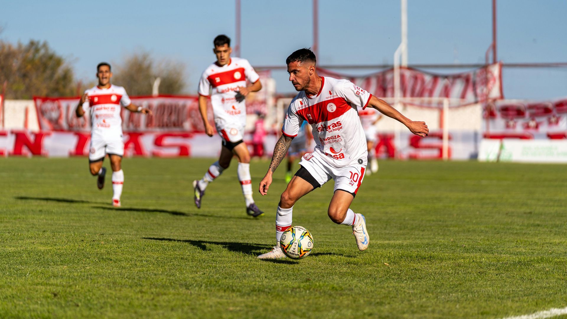 A group of men are playing soccer on a field.