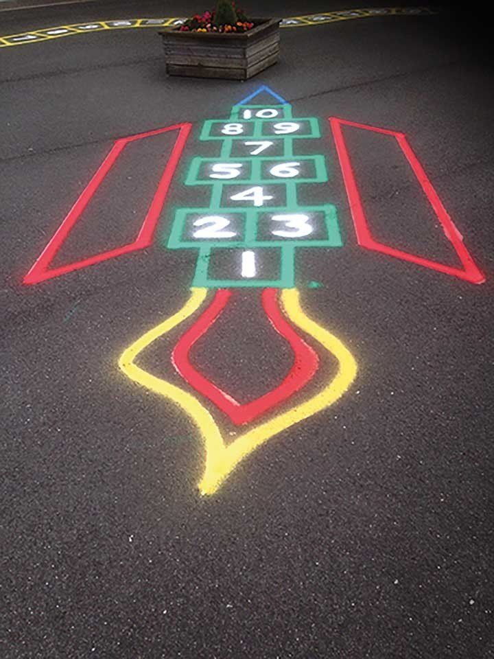 A hopscotch game is painted on the side of the road.