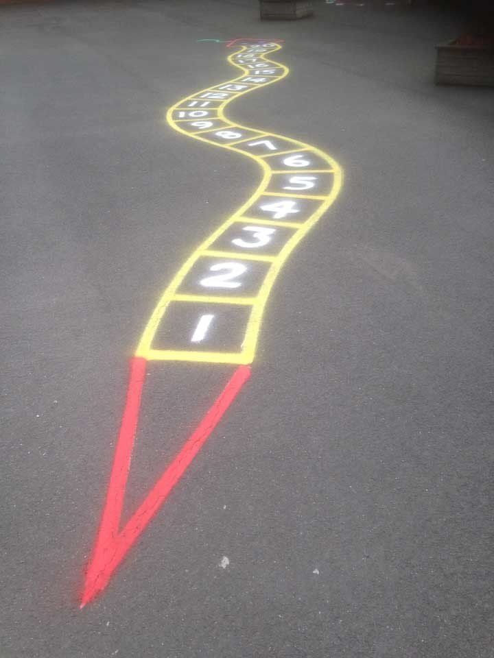 A snake is painted on the ground with numbers 1 through 12