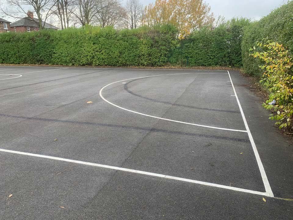 A basketball court with a white line on the side of it.