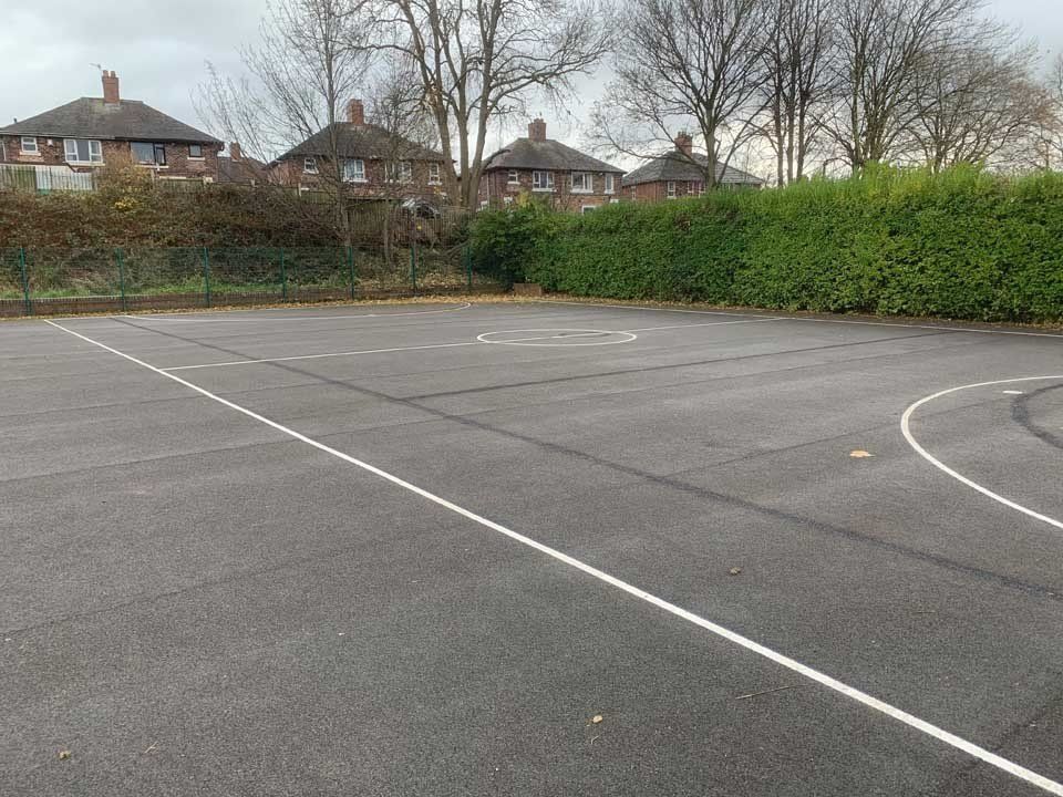 A basketball court with a white line in the middle of it.