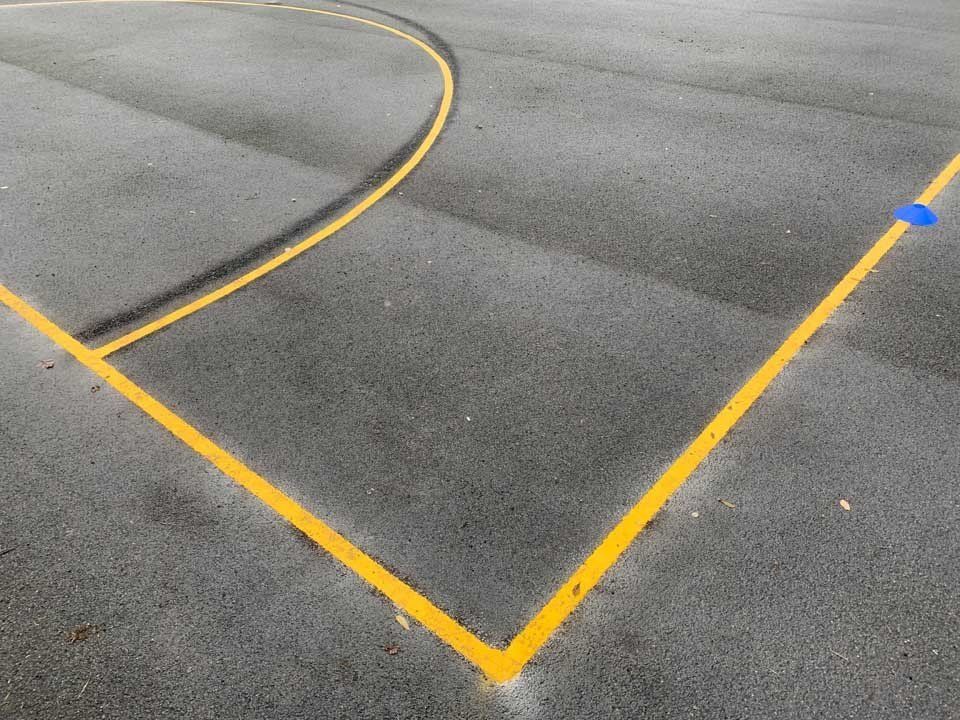 A yellow line is painted on the side of a road.