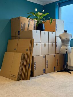 Photo of Removal boxes. Some boxes are full some are still flat packed