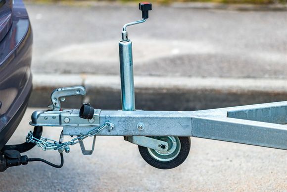 A trailer is attached to the back of a car.