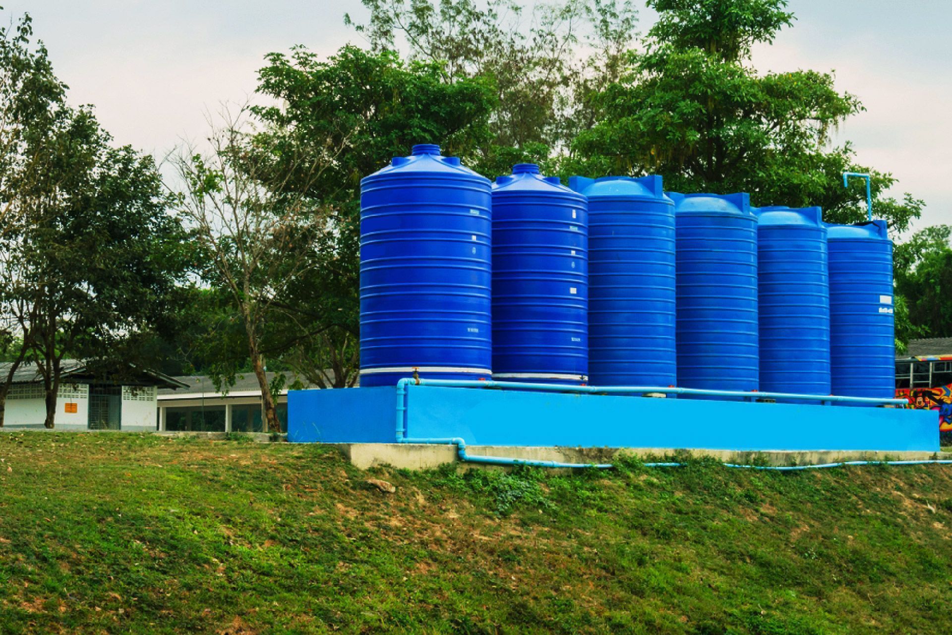 Blue Water Storage Tanks on a Blue Platform, Outdoors — Wilson's Drilling in South Kolan, QLD