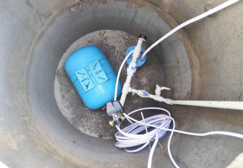 Blue Float Valve and Plumbing in a Concrete Water Tank — Wilson's Drilling in South Kolan, QLD
