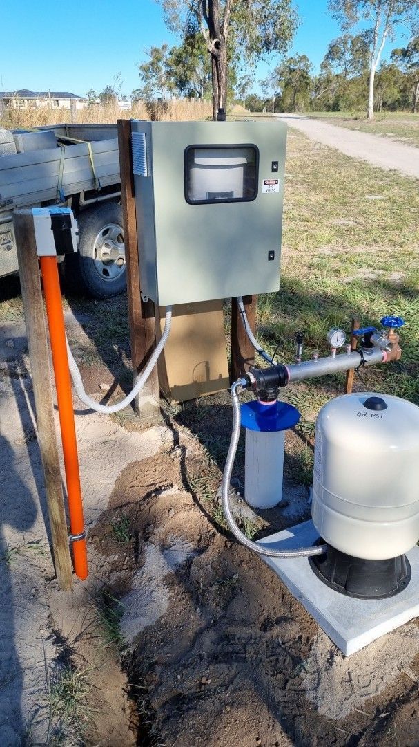 Outdoor Water Pump System With a Control Box, Filter, and Tank — Wilson's Drilling in South Kolan, QLD