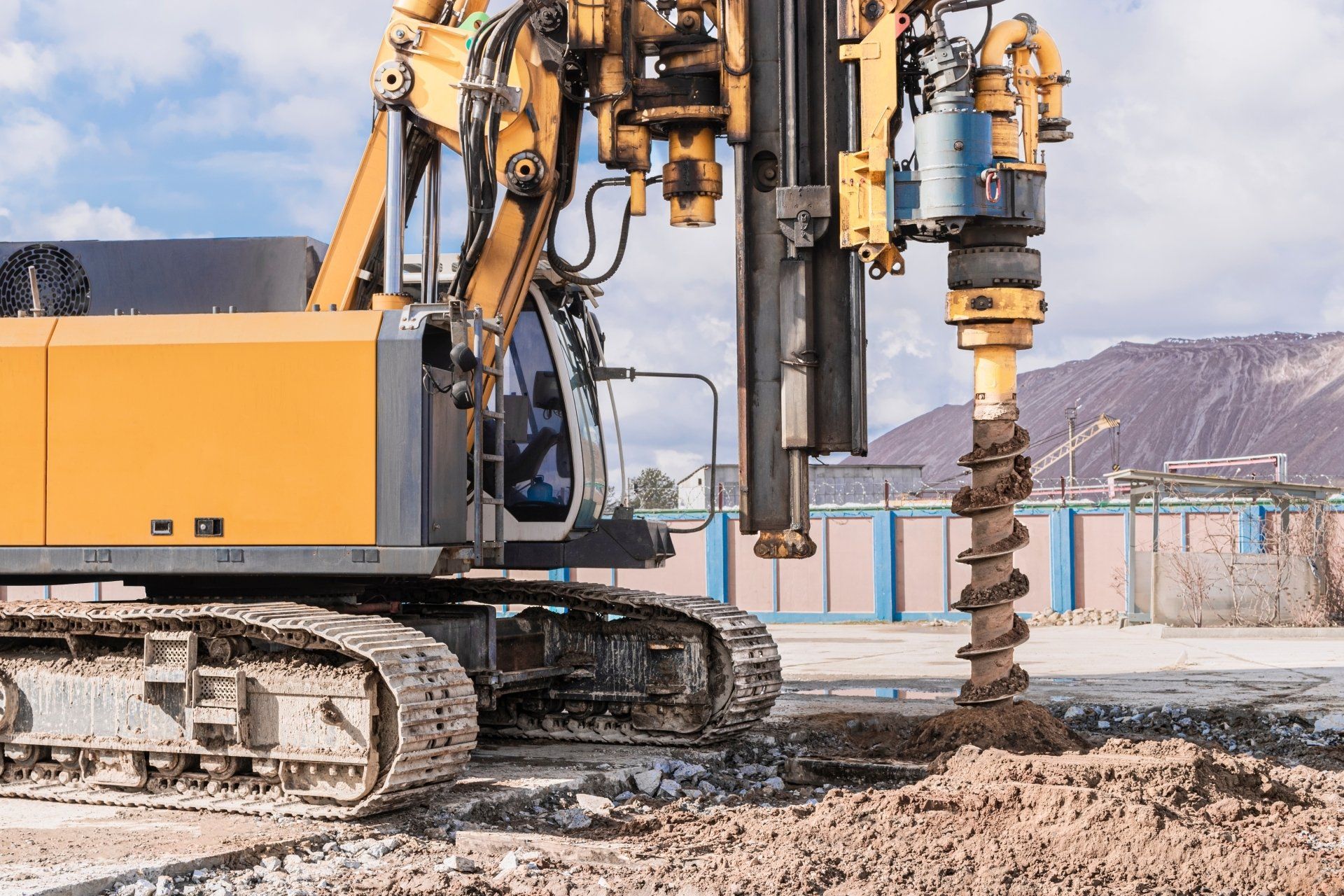 Yellow Drilling Machine Boring Into the Ground on a Construction Site — Wilson's Drilling in Bundaberg, QLD