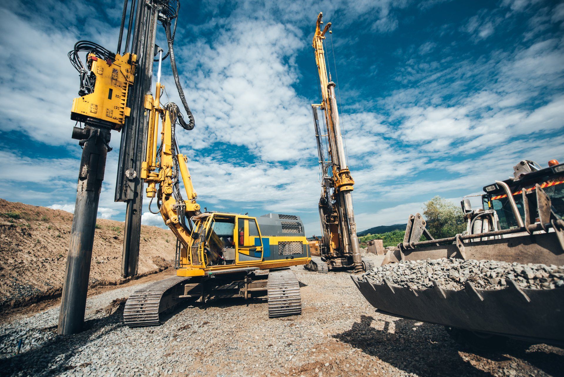 Yellow Construction Machinery Drilling on a Gravel Surface — Wilson's Drilling in Gin Gin, QLD