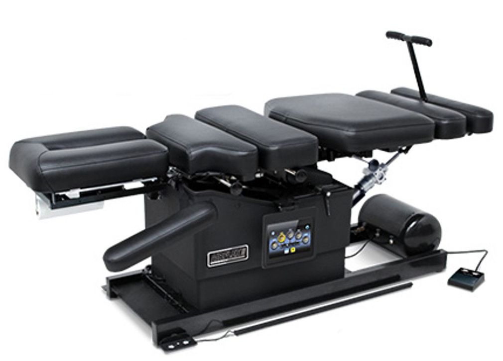 Flexion Distraction massage table is sitting on a white surface.