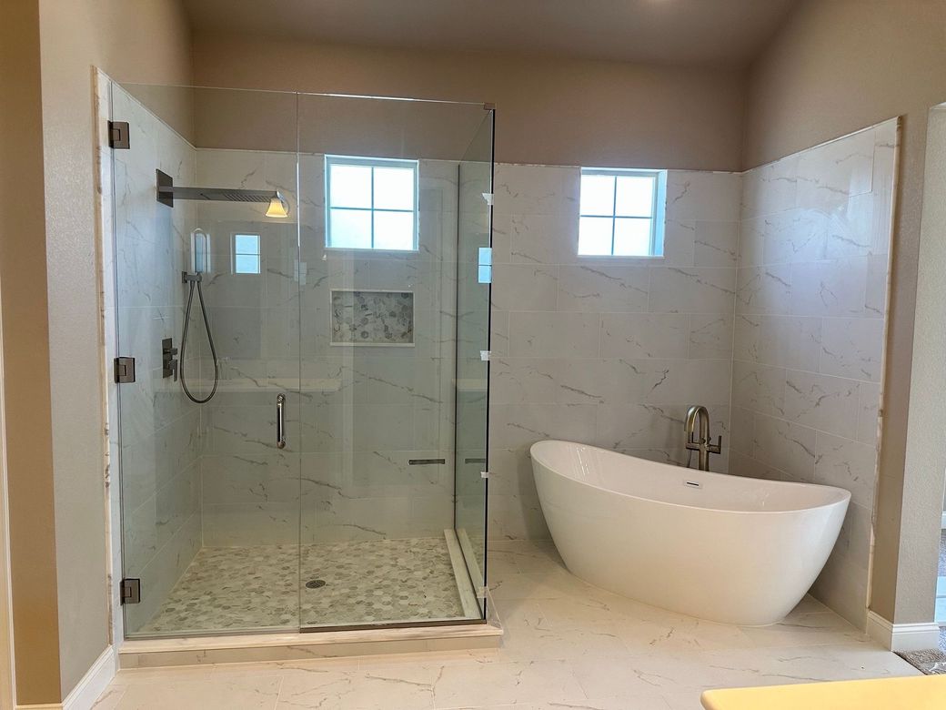 A bathroom with a toilet , sink , bathtub and mirror.