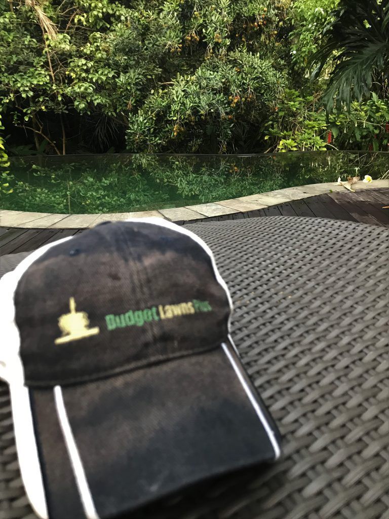 A Black and White Baseball Cap is Sitting on a Wicker Table | Central Coast, NSW | Budget Lawns Plus