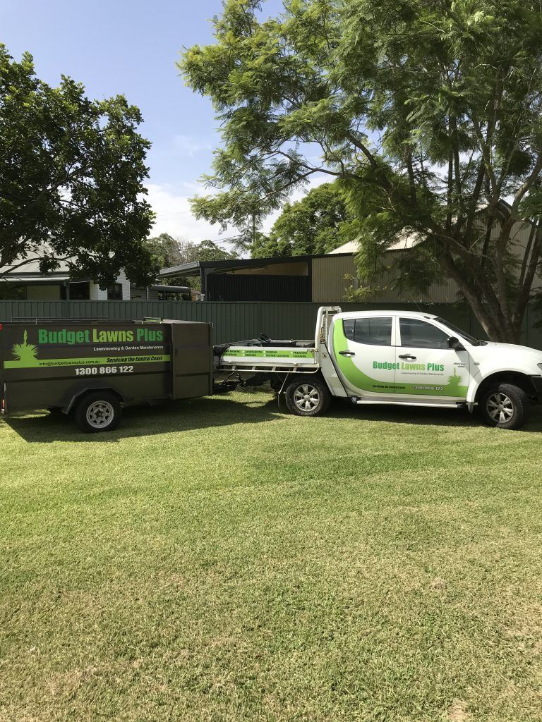 A Truck with a Trailer Attached to it is Parked in a Grassy Field | Central Coast, NSW | Budget Lawns Plus