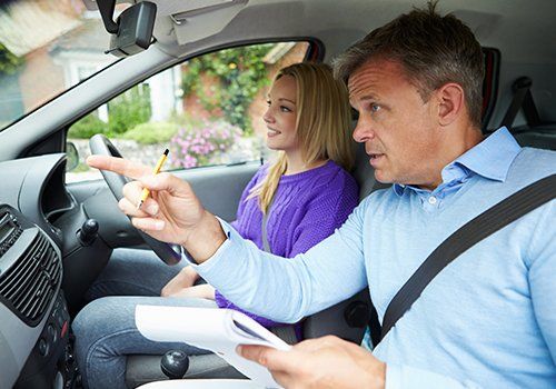 Driving School — Man Teaching Woman to Drive in Landham, MD