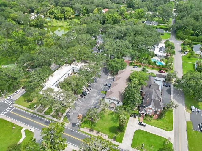 An aerial view of a residential area with lots of trees and houses.