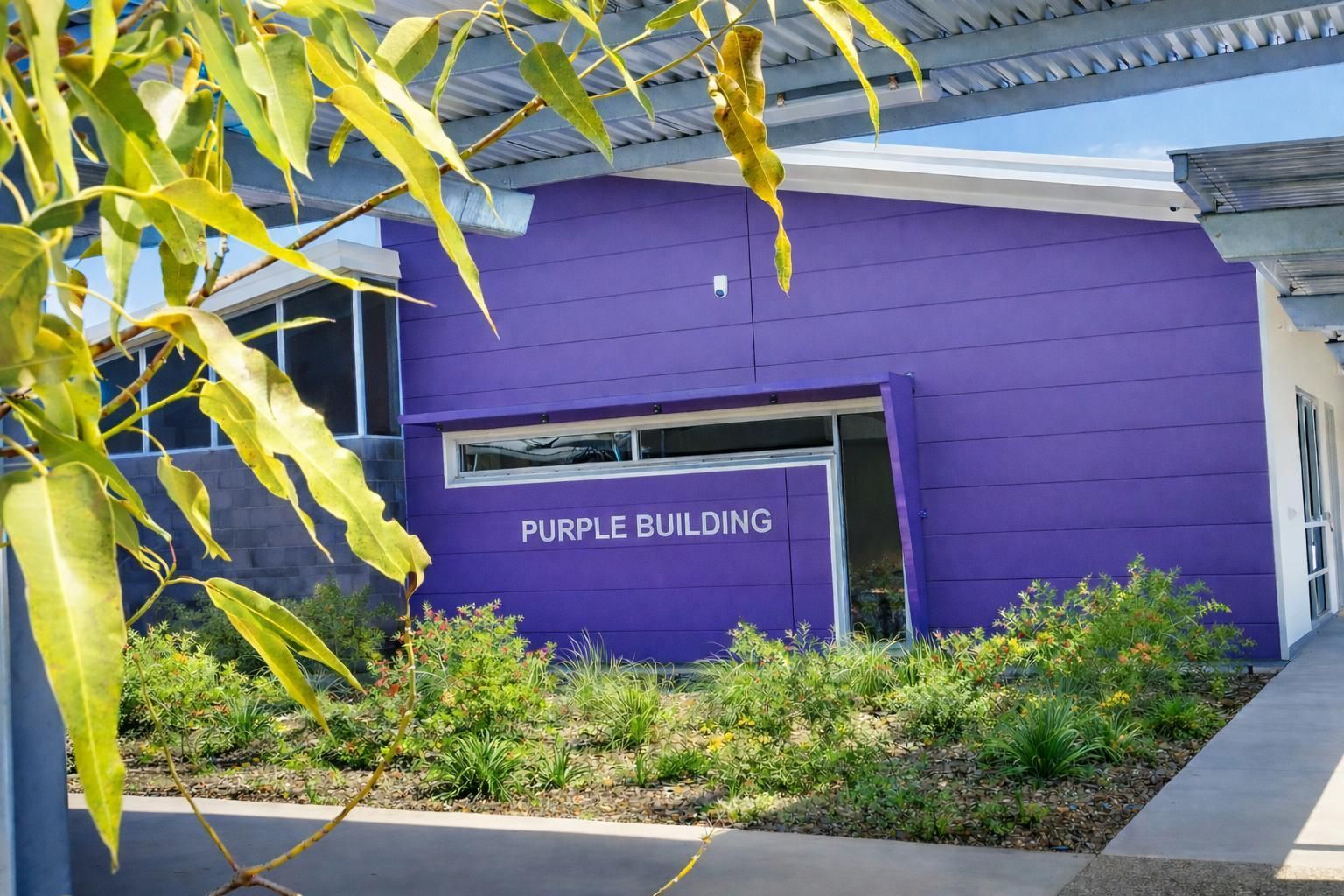 A bright purple building labeled 