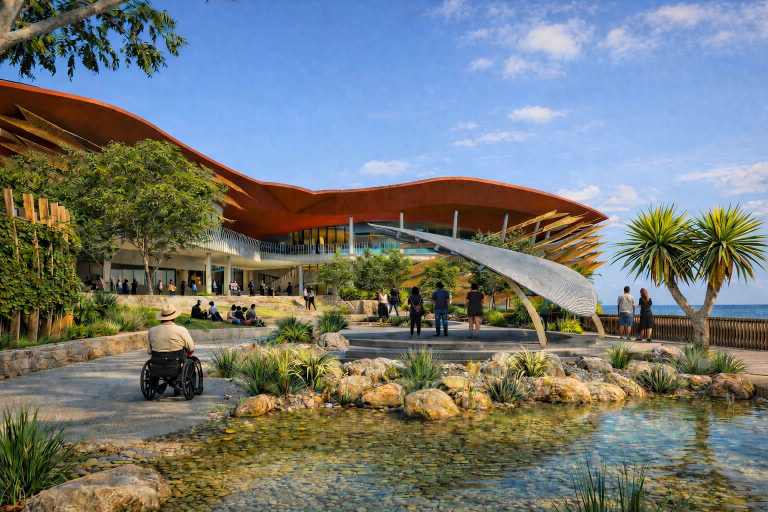 A person in a wheelchair faces a modern building with a sweeping, wavy orange roof, set in a sunny, landscaped garden.