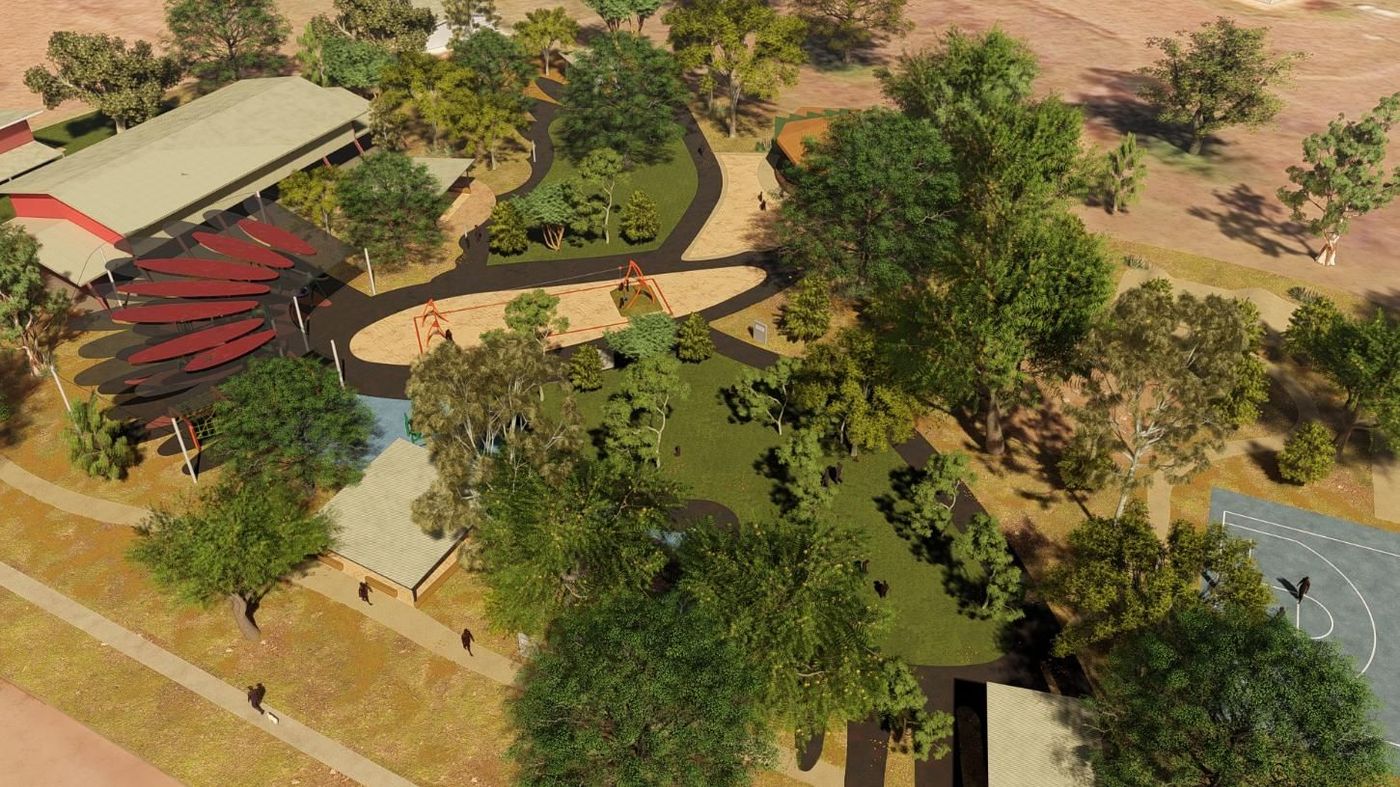 An open-plan preschool classroom with wooden floors, light green walls, child-sized furniture, and an art easel.