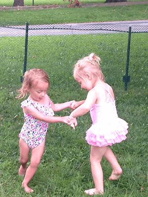 Two girls playing in grass - Nursery School in Conshoshocken, PA