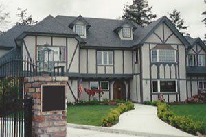 A large house with a brick pillar in front of it