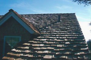 A wooden roof with a blue sky in the background