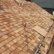 A wooden roof is being installed on a house.