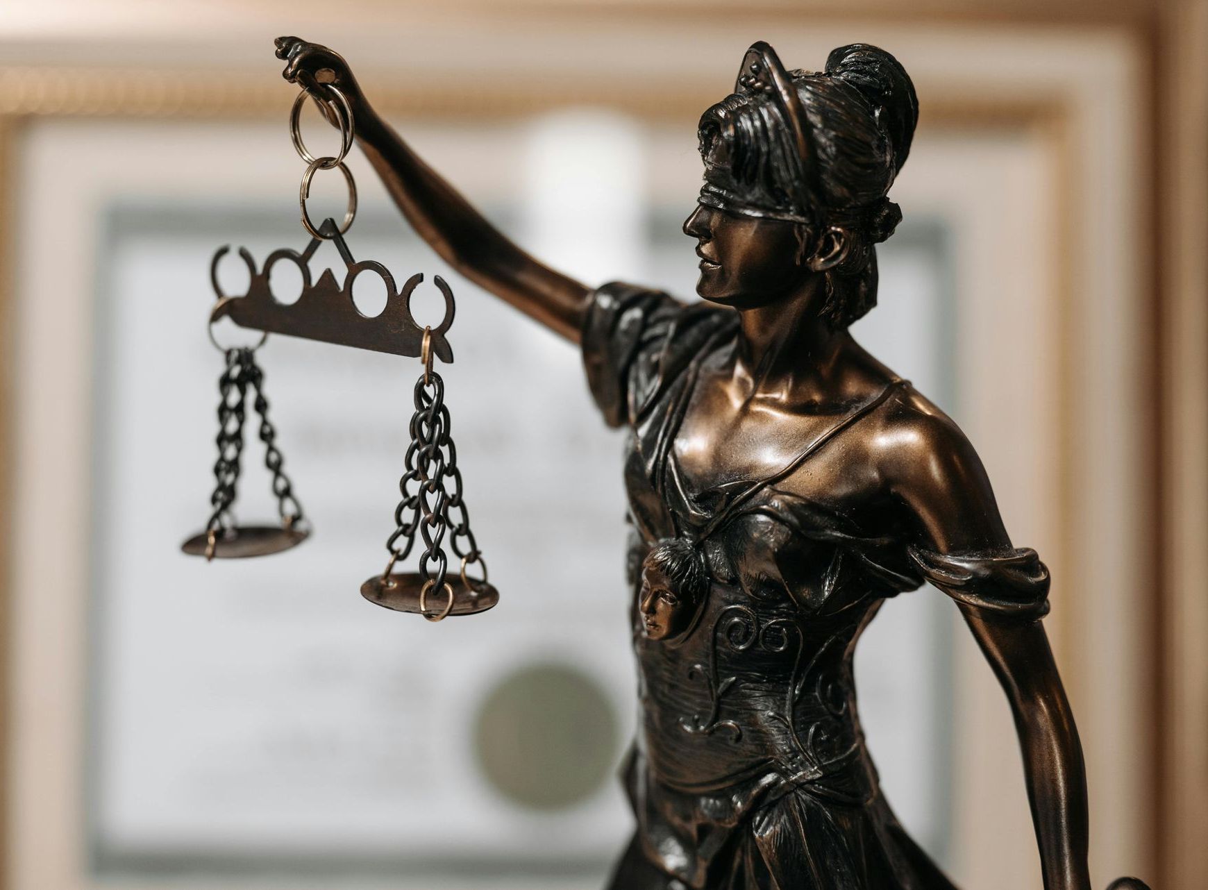 Statue of woman holding scales of justice, symbolizing legal services in personal injury & criminal defense.