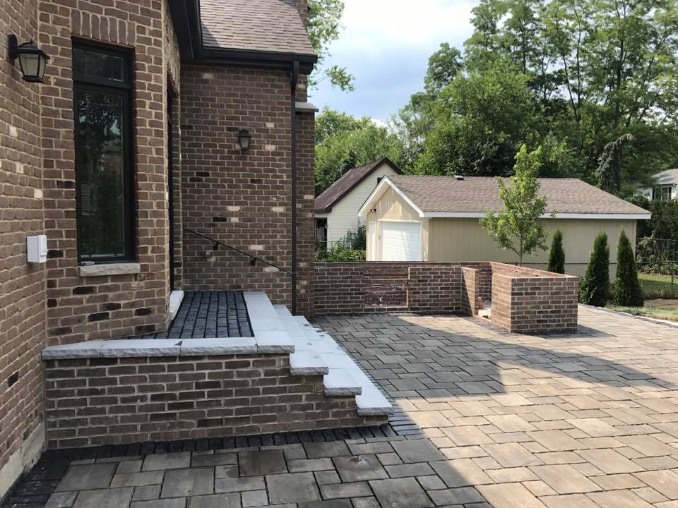 A brick house with a patio in front of it