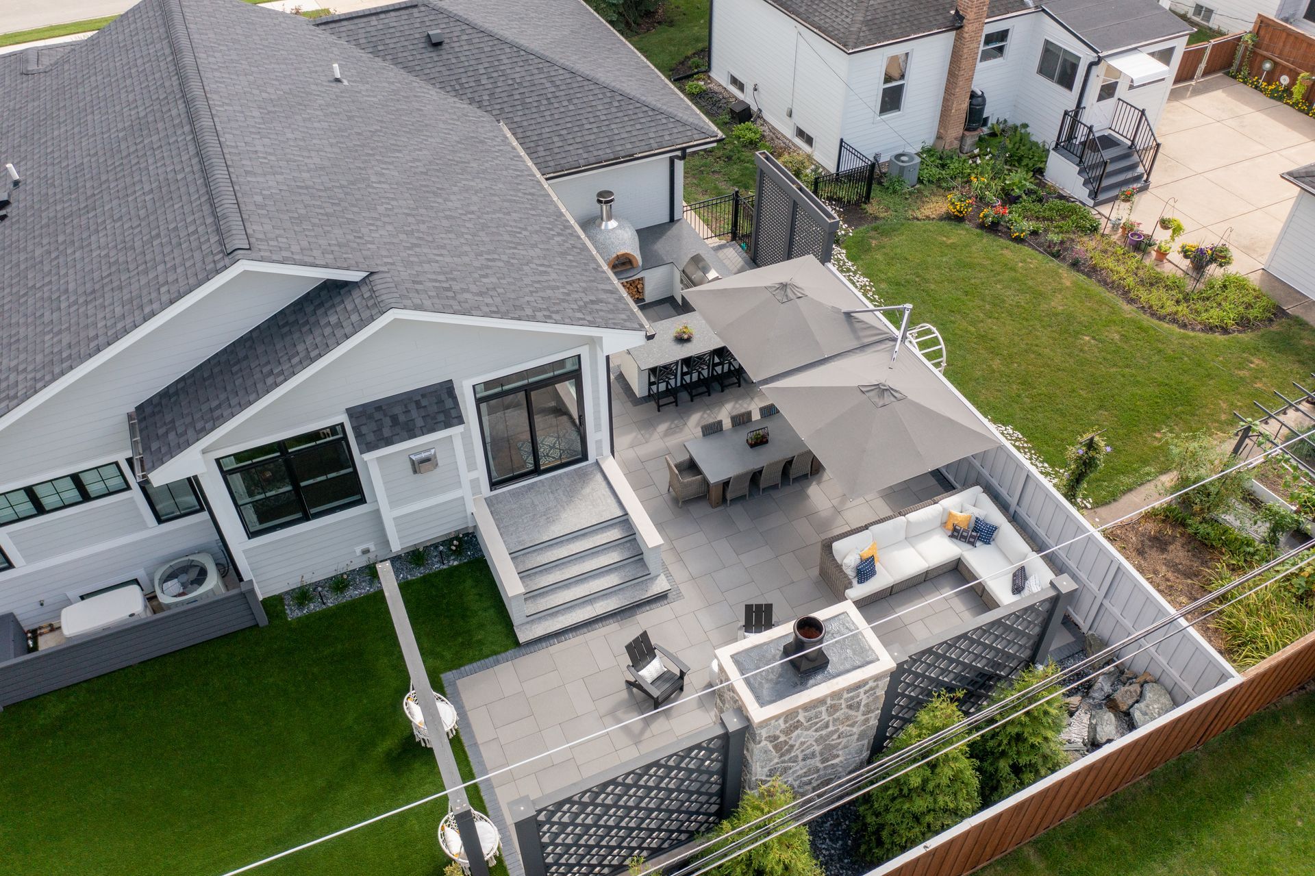 An aerial view of a house with a patio and a fence surrounding it.