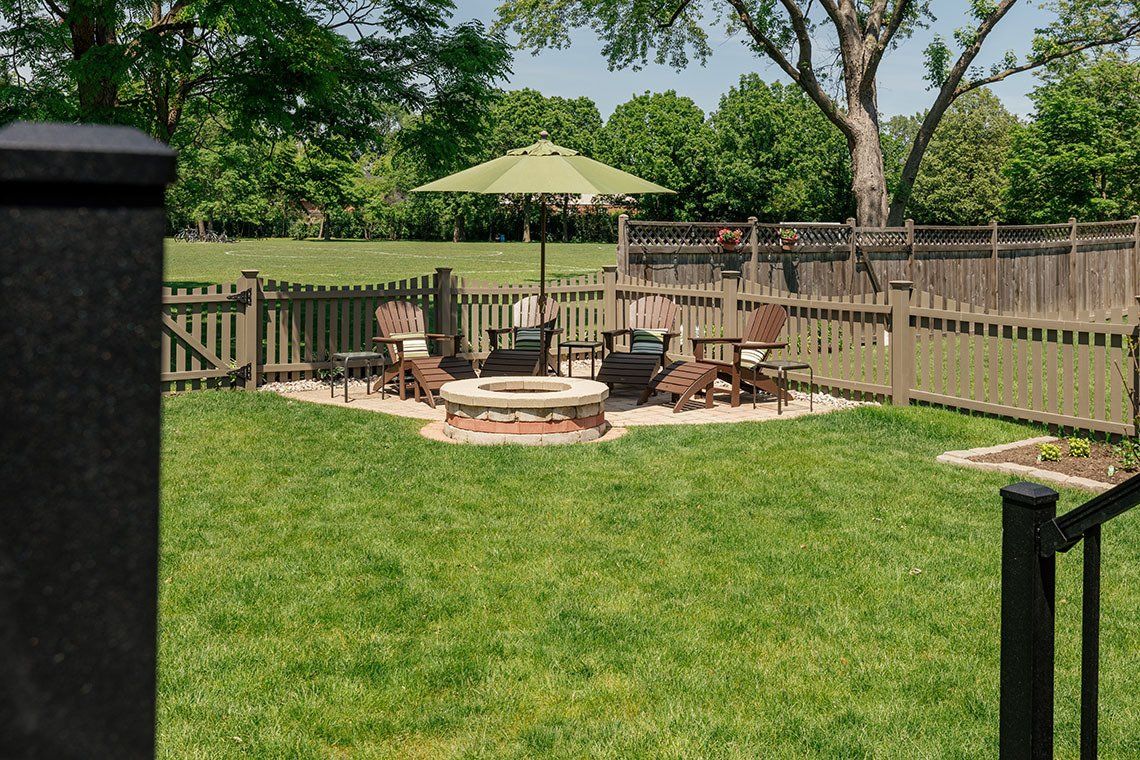 There is a fire pit in the middle of the backyard.