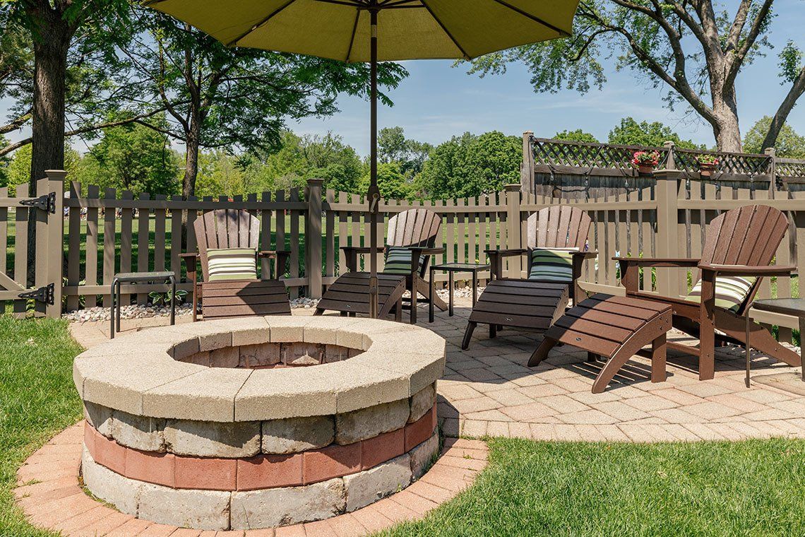 There is a fire pit in the middle of the backyard.