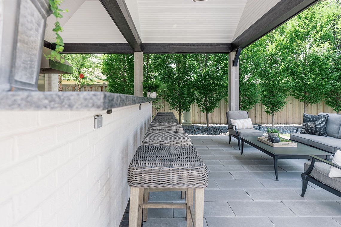 A patio with a table and chairs under a canopy.